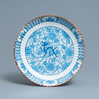 A ribbed Dutch Delft blue and white chinoiserie 'dragon' dish, 18th C.