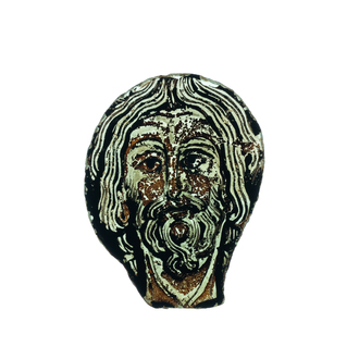 A Romanesque painted glass fragment depicting the head of Christ, France, 11/12th C.