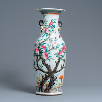 A Chinese famille rose molded 'nine peaches' vase, 19th C.