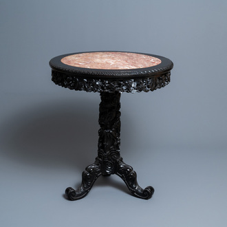 A round Chinese carved wooden marble top table, 19th C.