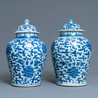 A pair of Chinese blue and white 'peony scroll' vases and covers, Kangxi