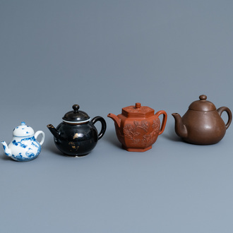 Four Chinese Yixing stoneware, blue and white and monochrome black porcelain teapots, Kangxi and later