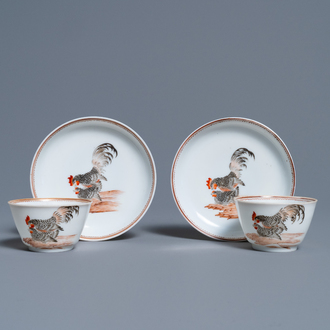 A pair of Chinese grisaille 'hen and rooster' cups and saucers, Yongzheng