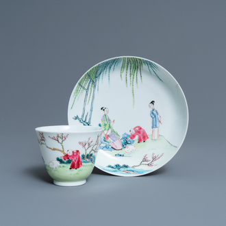 A Chinese famille rose cup and saucer with ladies and a boy playing with a rabbit, Yongzheng