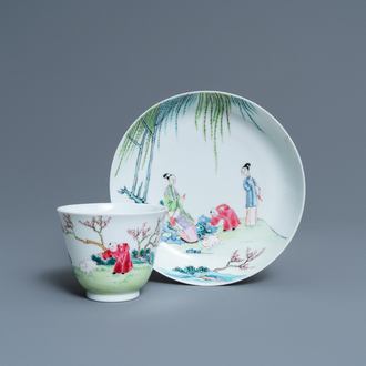 A Chinese famille rose cup and saucer with ladies and a boy playing with a rabbit, Yongzheng