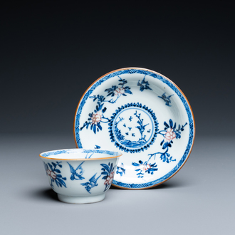 A Chinese blue, white and copper-red cup and saucer, Kangxi