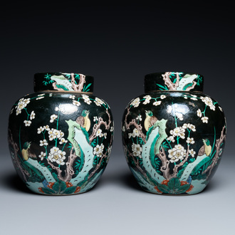 A pair of Chinese famille noire jars and covers, 19th C.