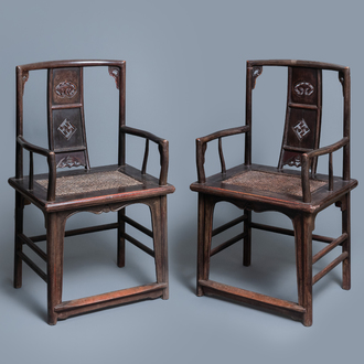 A pair of Chinese carved wooden chairs with wicker seats, 19th C.