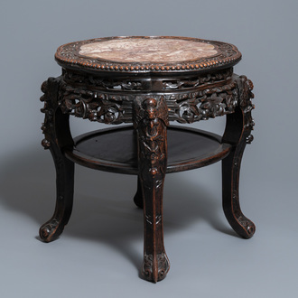 A Chinese carved wooden marble top stand, 19th C.