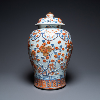 An exceptionally large Chinese Imari-style vase and cover with molded floral design, Kangxi