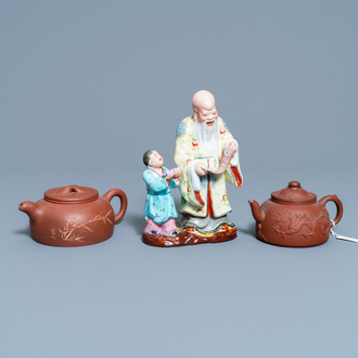 Two Chinese Yixing stoneware teapots and a famille rose 'Shou Lao' group, Kangxi and 20th C.