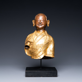 A Tibetan partly gilded brass bust of a Buddhist monk, 18th C.