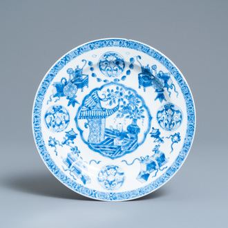 A Chinese blue and white plate with a boy surrounded by antiquities, ex-coll. August the Strong, Kangxi