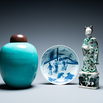 A Chinese verte biscuit figure, a green 'lotus' jar and a figurative blue and white plate, Kangxi and later