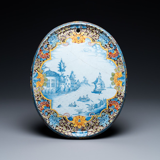 A Dutch Delft black-ground mixed technique oval plaque, 18th C.