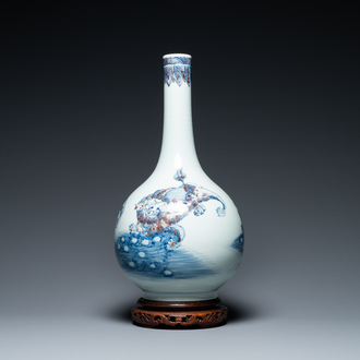 A Chinese blue, white and copper-red bottle vase with Buddhist lions, 20th C.