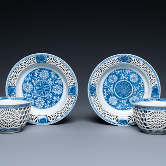 A pair of Chinese blue and white reticulated double-walled cups and saucers, Kangxi