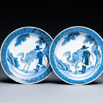 A pair of Japanese blue and white Arita saucer dishes with a Dutchman next to his camel, Edo, 17/18th C.