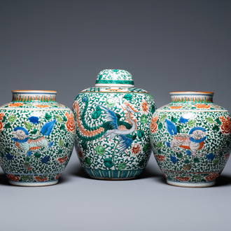 A pair of Chinese 'Buddhist lions' wucai vases and a covered 'phoenix' jar, 19th C.