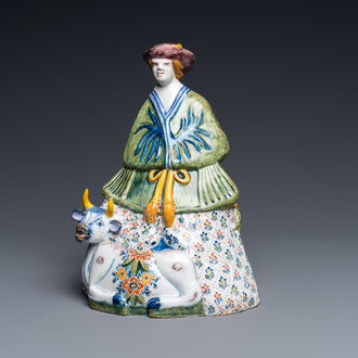 A polychrome Dutch Delft table bell in the shape of a lady on a cow, 18th C.