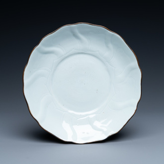 A Chinese molded white-glazed plate with incised lotus design, Xuande mark and of the period