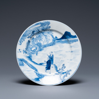A Chinese blue and white plate with two men in a landscape, Kangxi