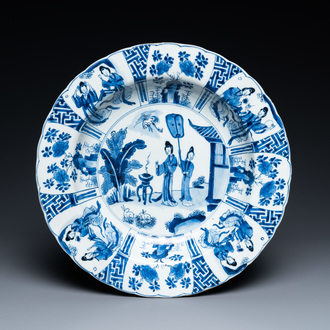 A Chinese blue and white dish with two ladies and two rabbits in a garden, Kangxi mark and of the period