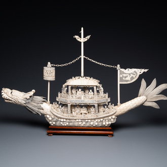 A Chinese carved ivory dragon boat on wooden stand, 19th C.