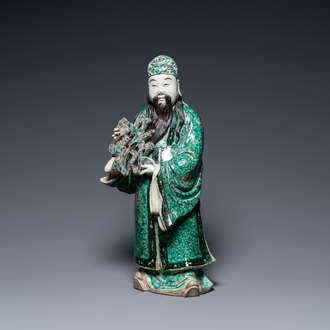 A Chinese verte biscuit figure of an immortal, 19th C.