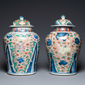 A pair of Chinese wucai 'galloping horses' vases and covers, Transitional period