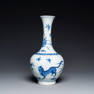 A rare Chinese blue and white bottle vase with a tiger and two butterflies, Transitional period