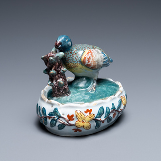 A polychrome Dutch Delft butter tub and cover with a bird, 18th C.