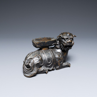 A rare Chinese bronze mythical animal 'Kaiming Shou' holding a lotus base, Ming