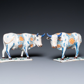 A pair of polychrome Dutch Delft cows on bases with frogs, 18th C.