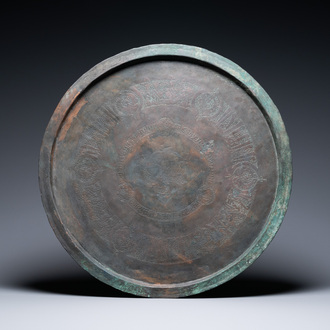 A large Seljuk bronze dish with engraved birds and Kufic inscriptions, Iran, 12/14th C.