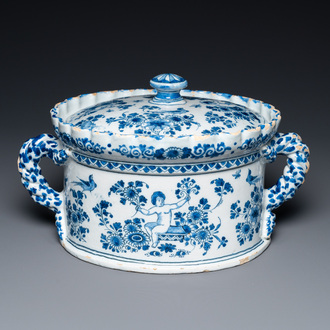 A Dutch Delft blue and white tureen and cover with putti, 17/18th C.
