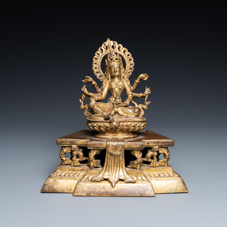 A Sino-Tibetan gilt bronze figure of Ushnishavijaya on a lotus throne with an inscription on the back, 18th C.