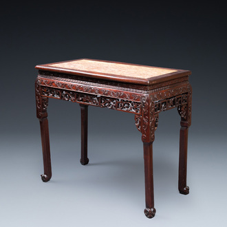 A Chinese rectangular carved wooden table with marble top, 19th C.