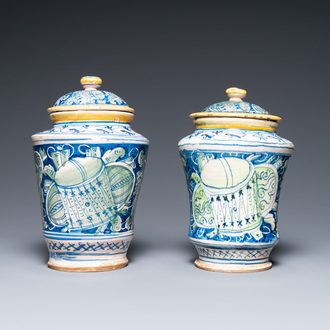 A pair of polychrome Italian maiolica covered albarelli with 'a trofei' design, Casteldurante, dated 1576