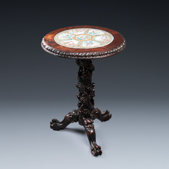 A Chinese wooden table with a Canton famille rose plaque, 19th C.