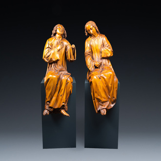 Two impressive Flemish carved oak figures of seated angels, 17th C.