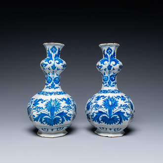 A pair of Dutch Delft blue and white 'garlic head' vases with lotus design, late 17th C.