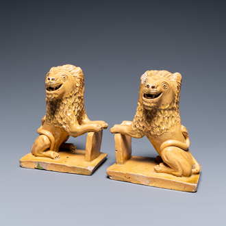 A pair of Flemish or North-French pottery lions, signed and dated 1865