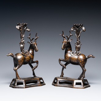 A pair of Chinese bronze deer-shaped candlesticks, Kangxi/Qianlong
