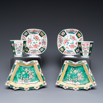 A pair of Chinese octagonal famille rose cups and saucers and a pair of verte biscuit dishes, Kangxi and Qianlong