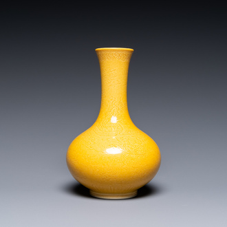 A Chinese monochrome yellow-glazed bottle vase with incised dragon design, Daoguang mark, 19/20th C.