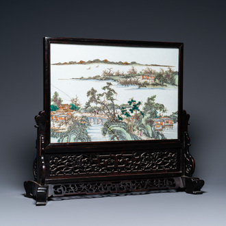 A Chinese rectangular famille rose 'landscape' plaque mounted in a wooden table screen, 19/20th C.