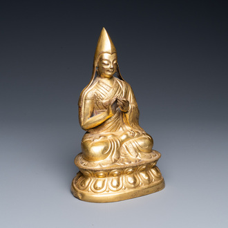 A Sino-Tibetan gilt bronze figure of a lamaic official or dignitary, probably 16th C.