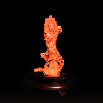 A large Chinese carved red coral 'Guanyin' figure, 19/20th C.