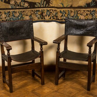 A pair of Spanish walnut chairs with leather backs and seats, 17th C.